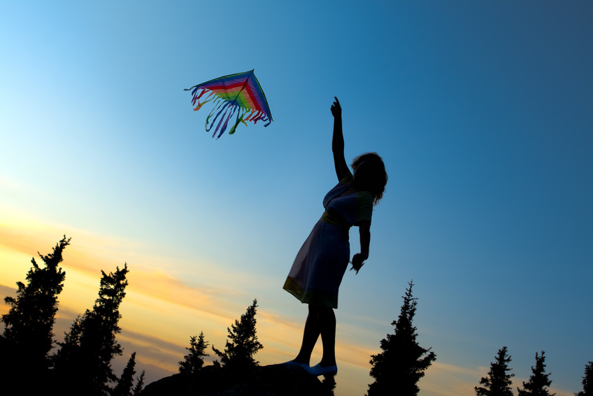 Young women flying a rainbow kite